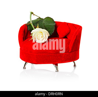 Red sofa, couch with white rose close-up isolated Stock Photo