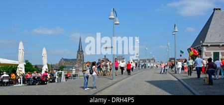 City of Maastricht people on Saint Servatius (Sint Servaasbrug) bridge over the river Meuse on a hot sunny summers July blue sky day Netherlands EU Stock Photo