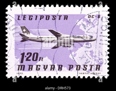 Postage stamp from Hungary depicting a Swiss Air DC-8 airplane and map of Southeast Asia. Stock Photo