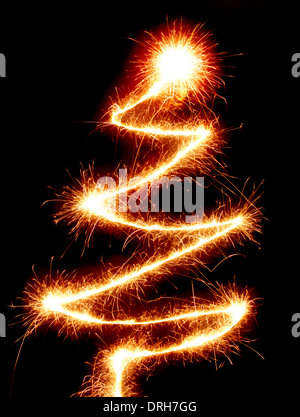 Christmas tree made with a sparkler isolated on black background conceptual symbol Stock Photo