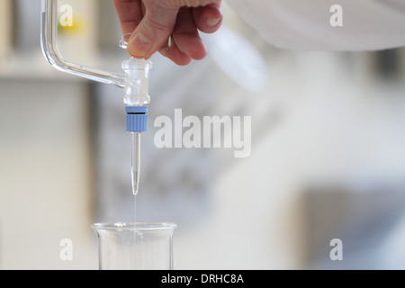 hand opens a burette Stock Photo