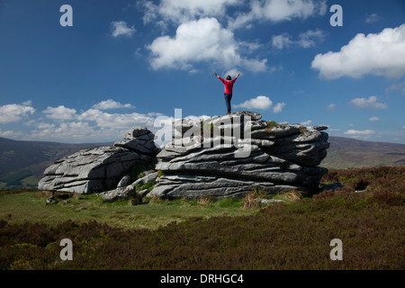 Walker on the granite tor of Fitzwilliam's Seat, near the summit of Knocknagun. On the border of counties Dublin and Wicklow, Ireland. Stock Photo
