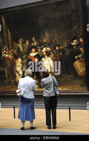 Holland. Amsterdam. Rijksmuseum. Women looking The Night Watch, painting by Rembrandt Harmenszoon van Rijn (1606-1669). Stock Photo