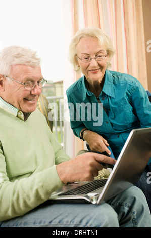 Senior couple using laptop in nursing home, Bavaria, Germany Stock Photo