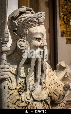 Closeup of carved warrior figure at Wat Pho, Bangkok. Stock Photo