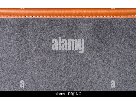detail of sewn beige leather binding on grey rug Stock Photo