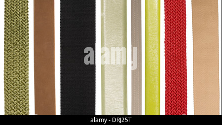 Closeup of various leather and fabric belts isolated on white background Stock Photo