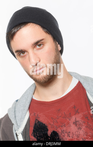 A young man dressed with a hoodie, poses as a gangster with a black eye. Stock Photo