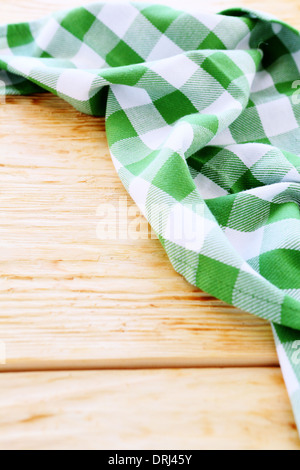 wooden table covered with green tablecloth Stock Photo