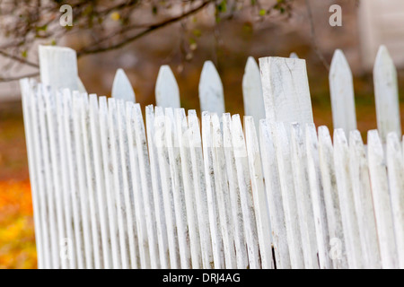 White slats on an old wooden fence in a rustic and rural countryside setting. Stock Photo