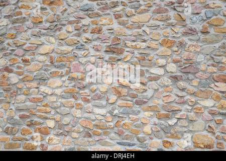 A newly built rough stone wall - backgrounds and textures Stock Photo