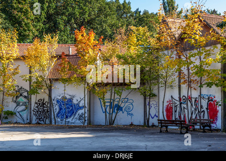 Graffiti covered walls in the courtyard of the English Village in Autumn at the abandoned amusement park, Spreepark, Plånterwald Stock Photo