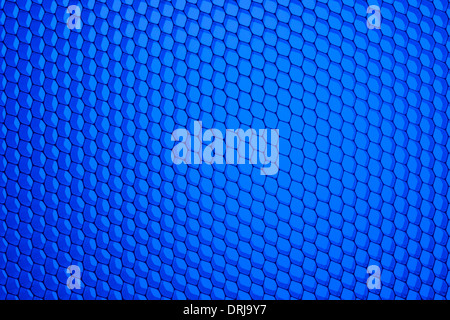 Honeycomb grid against blue background Stock Photo