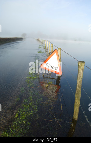 Flooded country road with warning sign Stock Photo - Alamy