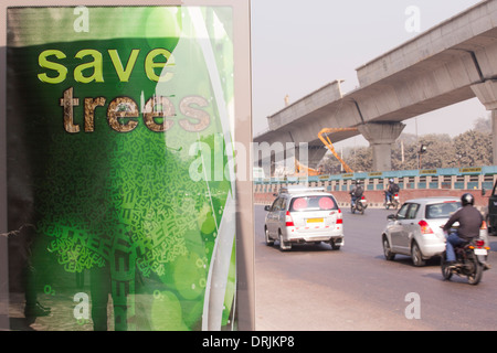 Construction work to extend the Delhi metro, India, with a save a tree poster. Stock Photo