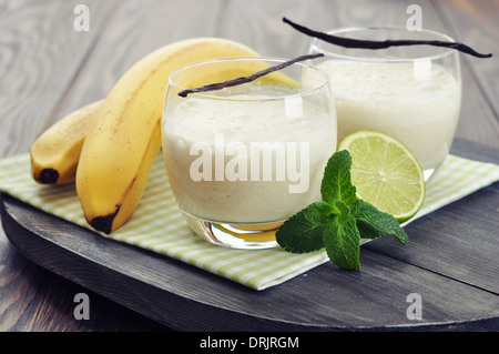 Banana milk shake in glass with vanilla, mint and lime Stock Photo