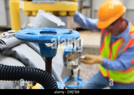 Engineer at electric power plant working with manual valves Stock Photo