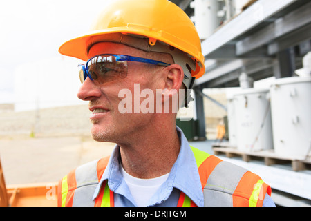 Engineer at electric power plant at storage area for transformers Stock Photo