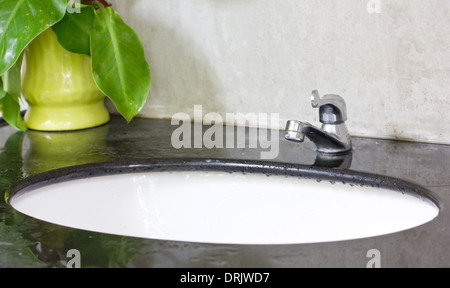 White ceramic washbasin and chrome tap. Stock Photo