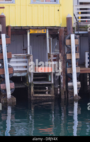 'Caution Low Beam,' reads a sign on a business at Fisherman's Wharf, Monterey Bay, California Stock Photo