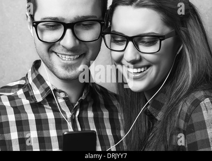 Young couple listening music together. Hipster style. Stock Photo