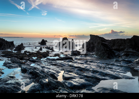 Low tide and sunrise at the beach at Looe in Cornwall Stock Photo