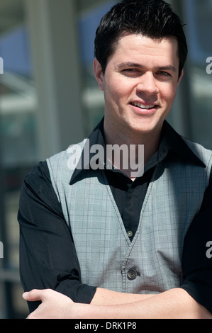 handsome young man portrait smiling waist up Stock Photo