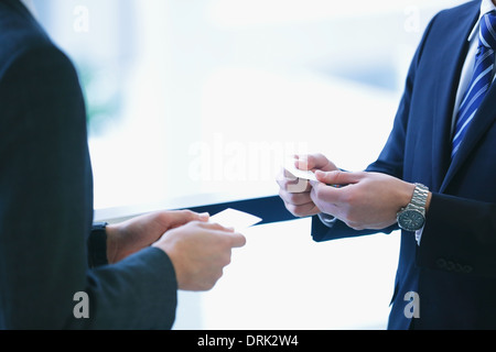 Businessmen exchanging name cards Stock Photo