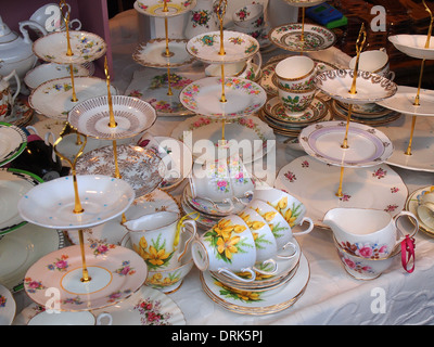 Stack of antique tea cups and plates on white background Stock Photo