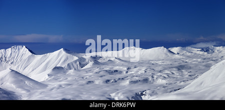 Panoramic view on snowy plateau and blue sky at nice day. Caucasus Mountains, Georgia, ski resort Gudauri. Stock Photo