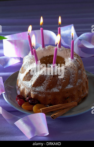 Selfmade birthday cake with six lighted candles on plate Stock Photo ...