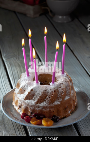 Selfmade birthday cake with six lighted candles on plate Stock Photo ...