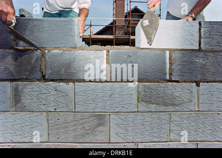 Bricklayers work on the construction of a new house. Stock Photo