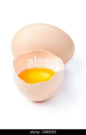 Broken egg with yolk and egg on white background Stock Photo