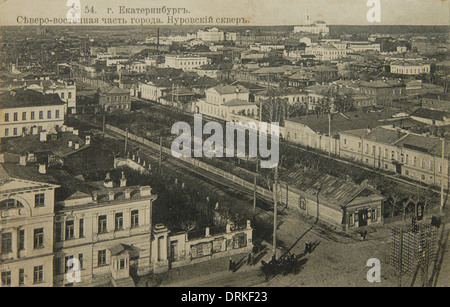 Aerial view of Yekaterinburg, Russian Empire. Black and white vintage photograph by Russian photographer Veniamin Metenkov dated from the beginning of the 20th century issued in the Russian vintage postcard published by Veniamin Metenkov himself in Yekaterinburg. Text in Russian: Yekaterinburg. North-Eastern part of the city. The Nurovsky Garden and Ascension Hill (Voznesenskaya gorka) with the Church of the Ascension (Voznesenskaya Church) are seen in the postcard. The view from the bell tower of St Catherine's Cathedral. Courtesy of the Azoor Postcard Collection. Stock Photo