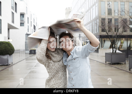 Young couple on the move in the rain Stock Photo