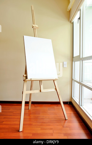 Blank canvas on a wooden tripod in the studio Stock Photo