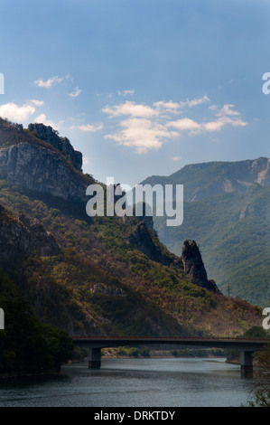 Rock spires and mountains above a bridge over a river, Bosnia and Herzegovina Stock Photo