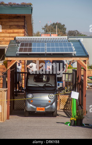 An electric powered 'eco car' is garaged under solar panels in an experimental energy efficient  solar powered home. Stock Photo