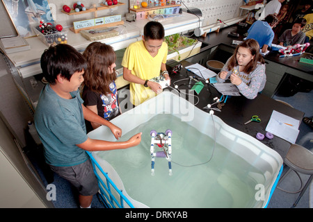 Multiracial middle school students in Mission Viejo, CA, test the remote operated vehicle (ROV) they built in robotics class Stock Photo