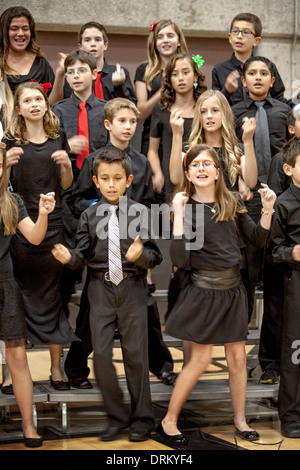 Multiracial middle school students sing Christmas carols at a school concert in Aliso Viejo, CA. Note matching black clothing. Stock Photo