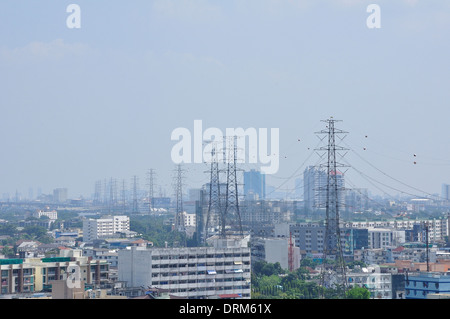 Electrical tower in field under blue sky Stock Photo