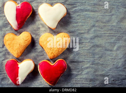 Six heart shape cookies on the paper with blank right side  Stock Photo