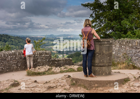 Symonds Yat Rock viewpoint, Gloucestershire, UK.  One woman surveying the landscape and the other reading orientation table. Stock Photo