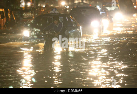 South Jakarta, Jakarta, Indonesia. 29th Jan, 2014. An Indonesian man wades through flood water. The capital's disaster management agency say, the number of refugees in Jakarta has shown a steep rise from 30,784 people recorded on 19 January, to 89,334 people on 22 January 2014. Authorities have warned of a possible worsening of the weather as the rainy season is set to last until February. Credit:  Afriadi Hikmal/ZUMA Wire/ZUMAPRESS.com/Alamy Live News Stock Photo