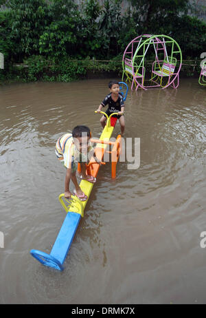 South Jakarta, Jakarta, Indonesia. 29th Jan, 2014. Children's playing in the park on flood water using rafts. The capital's disaster management agency say, the number of refugees in Jakarta has shown a steep rise from 30,784 people recorded on 19 January, to 89,334 people on 22 January 2014. Authorities have warned of a possible worsening of the weather as the rainy season is set to last until February. Credit:  Afriadi Hikmal/ZUMA Wire/ZUMAPRESS.com/Alamy Live News Stock Photo