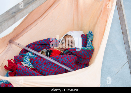 A baby in a hammock in Rajasthan, India. Stock Photo