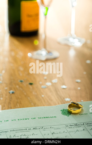 Two gold rings, lying on a marriage certificate. Stock Photo