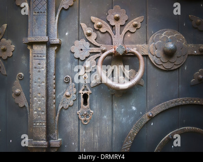 Ornate ironmongery fittings on old door of St Peter's church Hampton Lucy Warwickshire UK Stock Photo