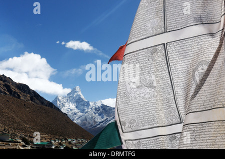 A prayer flag in the village of Khumjung on the everest base camp trek with Ama Dablam beyond Stock Photo